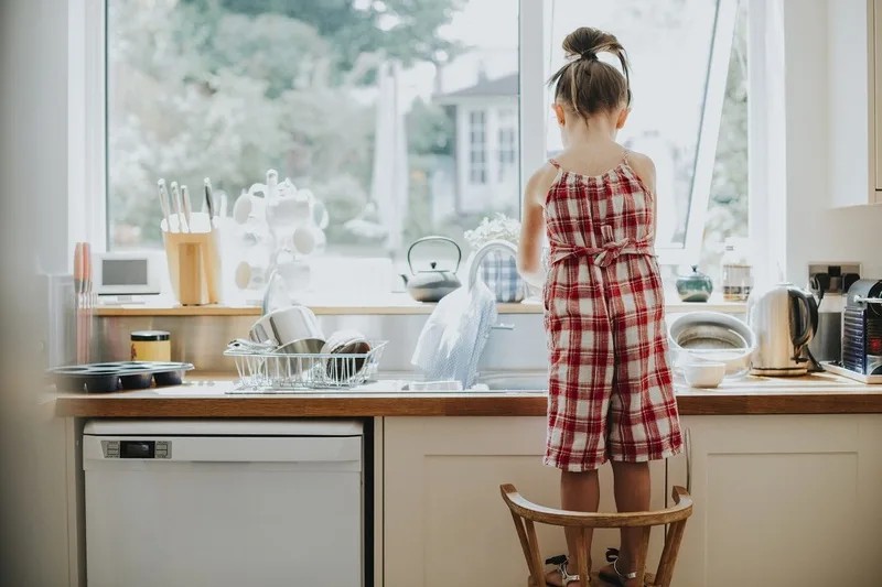 Cô bé đang rửa bát đĩa