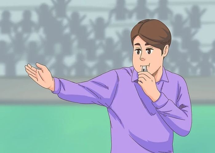 Trọng tài thổi còi và chỉ tay về trước